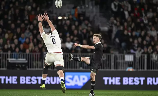 England's George Martin attempts to block a kick from New Zealand's Damian McKenzie during their rugby union test match in Dunedin, New Zealand, Saturday July 6, 2024. (Andrew Cornaga/Photosport via AP)