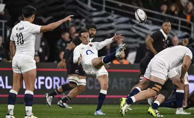 England's Alex Mitchell of England center, kicks the ball down field against New Zealand during their rugby union test match in Dunedin, New Zealand, Saturday July 6, 2024. (Andrew Cornaga/Photosport via AP)