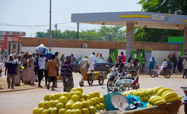 Oranges and bananas are display for sell on a street in Niamey, Niger, Wednesday, July. 24, 2024. One year has passed since a dramatic coup in Niger. (AP Photo/Omar Hama)