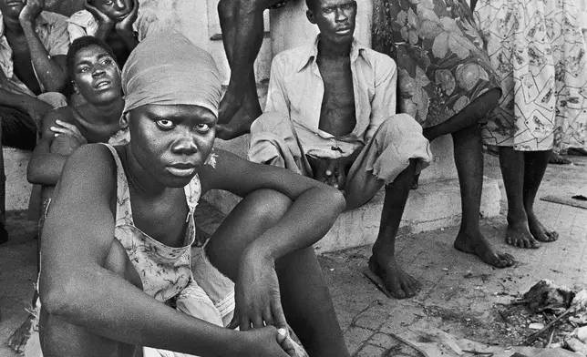 FILE - Haitian refugees living on Cayos Lobos, Bahamas, gather on Nov. 12, 1980. They were part of a group of 102 Haitian refugees stranded on the island for 39 days. (AP Photo/ Kathy Willens, File)