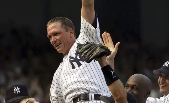 FILE - New York Yankees pitcher David Cone is lifted onto the shoulders of his teammates by catcher Joe Girardi, left, as manager Joe Torre joins in the celebration after Cone threw a perfect game against the Montreal Expos during "Yogi Berra Day" at New York's Yankee Stadium, July 18, 1999. (AP Photo/Kathy Willens, File)