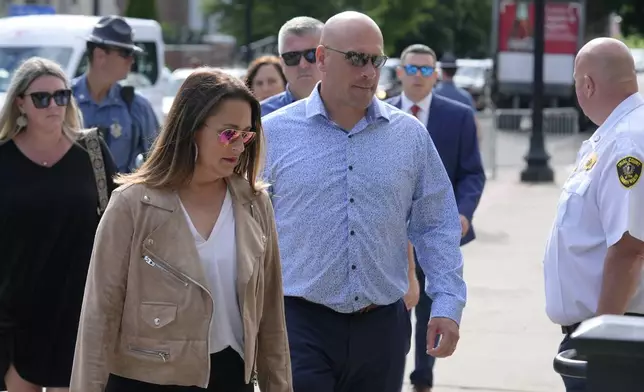 Paul O'Keefe, center, brother of the late Boston police Officer John O'Keefe, enters Norfolk Superior Court with his wife Erin O'Keefe, front left, Monday, July 1, 2024, in Dedham, Mass. Read is on trial, accused of killing her boyfriend John O'Keefe, in 2022. The jury began deliberations in the trial Tuesday, June 25. (AP Photo/Steven Senne)