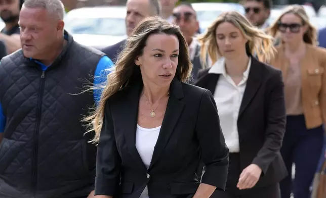 Karen Read, center, arrives at Norfolk Superior Court, Monday, July 1, 2024, in Dedham, Mass. Read is on trial, accused of killing her boyfriend Boston police Officer John O'Keefe, in 2022. The jury began deliberations in the trial Tuesday, June 25. (AP Photo/Steven Senne)