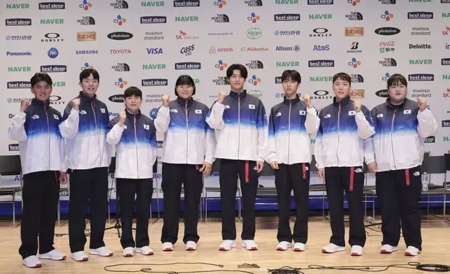 South Korean national team members wear uniforms for the medal ceremony for the Paris 2024 Olympic Games during a media day at the Korean National Training Center in Jincheon, South Korea, on June 26, 2024. (Kim In-cheul/Yonhap via AP)