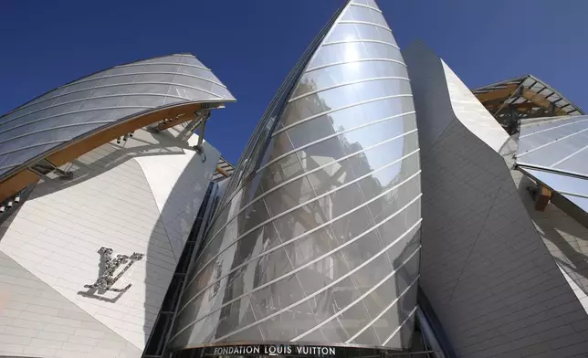 FILE - The Louis Vuitton Foundation building designed by American architect Frank Gehry is pictured before the presentation of Louis Vuitton's Spring/Summer 2015 ready-to-wear fashion collection in Paris, Wednesday, Oct. 1, 2014. With a major sponsorship role aimed at burnishing the image of the Paris 2024 Summer Olympic Games and the French capital, it's a new chapter in LVMH's specialty of selling exclusivity at a grand scale under its chair and CEO, Bernard Arnault. (AP Photo/Francois Mori, File)