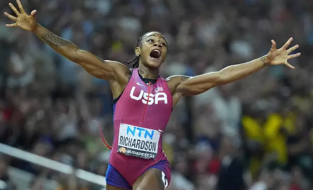 FILE - Sha'Carri Richardson, of the United States, celebrates after winning the gold medal in the final of the Women's 100-meters during the World Athletics Championships in Budapest, Hungary, Aug. 21, 2023. (AP Photo/Petr David Josek, File)