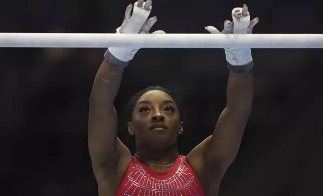 FILE - Simone Biles practices on the bars ahead of the U.S. Gymnastics Olympic Trials Wednesday, June 26, 2024, in Minneapolis. (AP Photo/Abbie Parr, File)