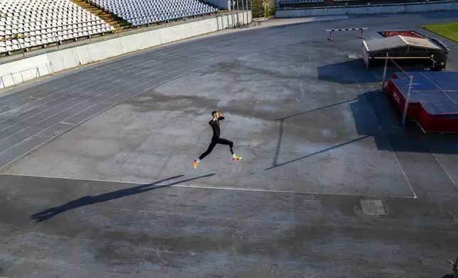 High jumper Oleh Doroshchuk works out during a training session at Zirka stadium, in Kropyvnytskyi, Ukraine, Friday, April 19, 2024. (AP Photo/Francisco Seco)