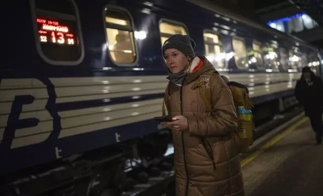 Hurdler Anna Ryzhykova walks on a platform before departing for Poland at the train station in Kyiv, Ukraine on Tuesday, Jan. 9, 2024. “Our victories are to draw attention to Ukraine,” Ryzhykova says. (AP Photo/Evgeniy Maloletka)