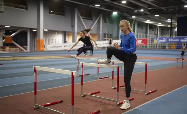 Hurdler Anna Ryzhykova trains at the sports center in Kyiv, Ukraine on Monday, Jan. 8, 2024. (AP Photo/Evgeniy Maloletka)