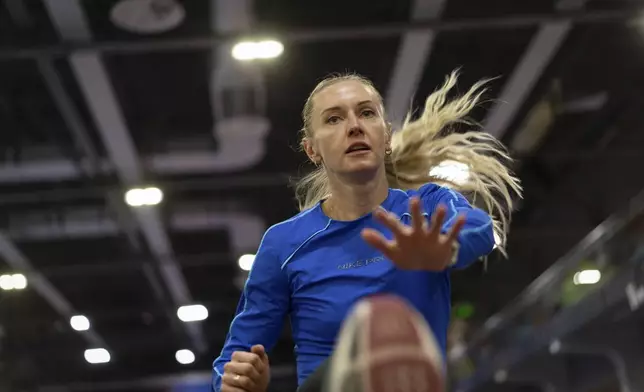 Hurdler Anna Ryzhykova trains at the sports center in Kyiv, Ukraine on Monday, Jan. 8, 2024. Her competitions are no longer strictly an individual battle, but war on a different front. Her goal is not just gold, but also to rivet global attention on her country’s fight for survival against Russia. “You’re not doing it for yourself anymore,” she says. “Winning a medal just for yourself, being a champion, realizing your ambitions — it’s inappropriate.” (AP Photo/Evgeniy Maloletka)