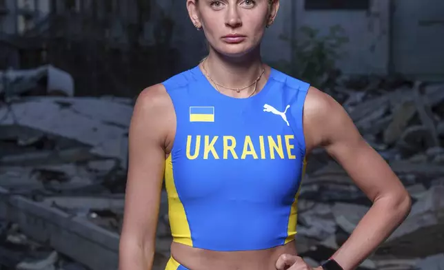 Kateryna Tabashnyk, a high jumper, stands for a portrait Sunday, June 9, 2024, at the athletics arena of the "Polytechnic" sports complex, which was destroyed by a Russian rocket attack, in Kharkiv, Ukraine. (AP Photo/Evgeniy Maloletka)