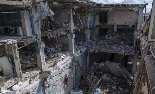 A house destroyed by a Russian missile where Kateryna Tabashnyk's mother was killed on Aug. 18, 2022, in Kharkiv, Ukraine, is seen on Friday, June 7, 2024. (AP Photo/Evgeniy Maloletka)