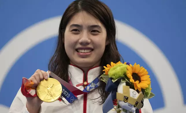 FILE - Zhang Yufei of China poses with her gold medal after winning the women's 200-meter butterfly final at the 2020 Summer Olympics, on July 29, 2021, in Tokyo, Japan. (AP Photo/Matthias Schrader, File)