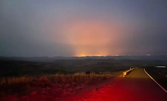 In this image provided by the Oregon Department of Transportation, the Durkee fire burns in the background as it nears Interstate 84 near Huntington, Ore., early Sunday, July 21, 2024. (Oregon Department of Transportation via AP)