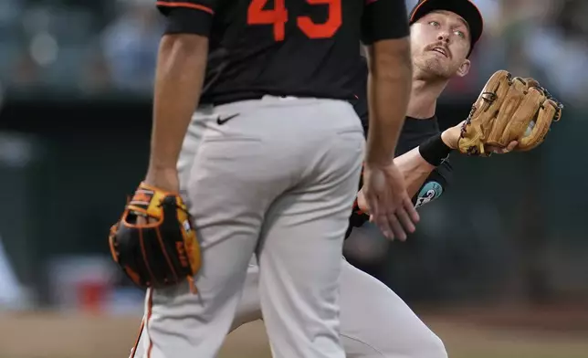 Baltimore Orioles third baseman Jordan Westburg, right, catches a popup hit by Oakland Athletics' Max Schuemann during the fifth inning of a baseball game Friday, July 5, 2024, in Oakland, Calif. (AP Photo/Godofredo A. Vásquez)