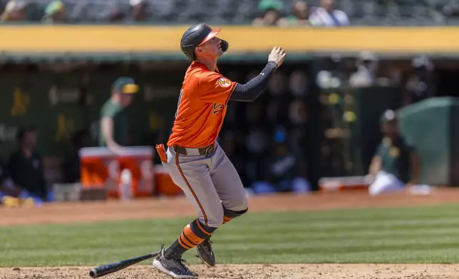 Baltimore Orioles' Austin Hays hits a sacrifice fly for an RBI against the Oakland Athletics during the fourth inning of a baseball game Saturday, July 6, 2024, in Oakland, Calif. (AP Photo/John Hefti)