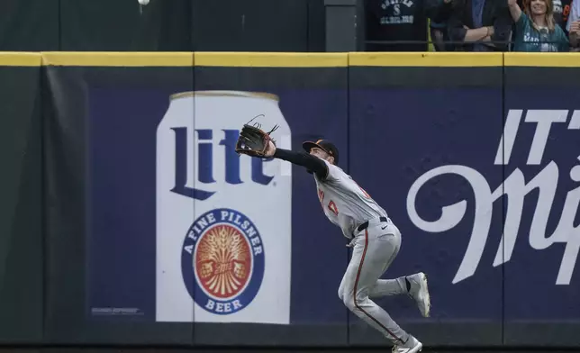 Baltimore Orioles left fielder Colton Cowser fields a fly ball during the eighth inning of a baseball game against the Seattle Mariners, Tuesday, July 2, 2024, in Seattle. (AP Photo/Stephen Brashear)