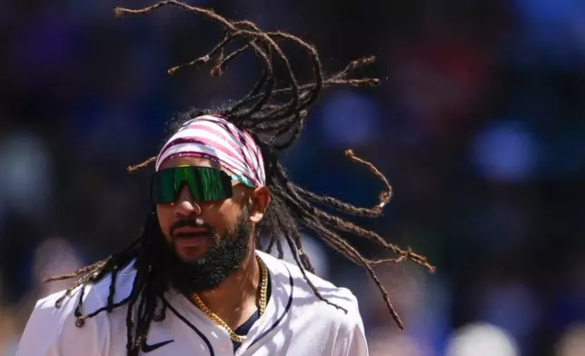 Seattle Mariners' J.P. Crawford's hair flies after stealing second base against the Baltimore Orioles during the first inning of a baseball game Thursday, July 4, 2024, in Seattle. (AP Photo/Lindsey Wasson)