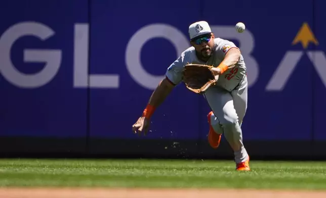 Baltimore Orioles right fielder Anthony Santander makes a diving catch on a fly ball hit by Seattle Mariners' Cal Raleigh during the first inning of a baseball game Thursday, July 4, 2024, in Seattle. (AP Photo/Lindsey Wasson)