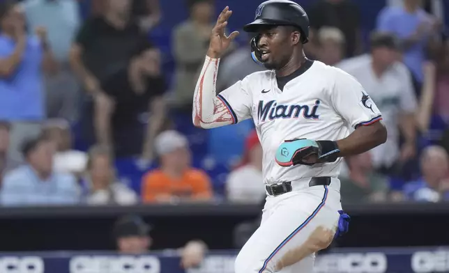 Miami Marlins' Jesús Sánchez heads for home to score on a single by Xavier Edwards during the fourth inning of a baseball game against the Baltimore Orioles, Wednesday, July 24, 2024, in Miami. (AP Photo/Wilfredo Lee)