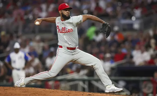 FILE - Philadelphia Phillies relief pitcher Seranthony Dominguez delivers in the eighth inning of a baseball game against the Atlanta Braves, Saturday, July 6, 2024, in Atlanta. The Philadelphia Phillies acquired outfielder Austin Hays from the Baltimore Orioles on Friday, July 26, 2024, in exchange for right-handed pitcher Seranthony Domínguez and outfielder Cristian Pache, in a deal between the East Division leaders in both leagues. (AP Photo/Brett Davis, File)