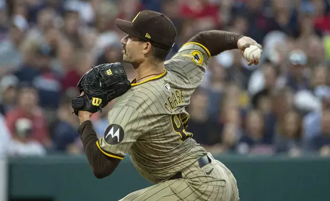 San Diego Padres starting pitcher Dylan Cease delivers against the Cleveland Guardians during the fifth inning of a baseball game in Cleveland, Saturday, July 20, 2024. (AP Photo/Phil Long)