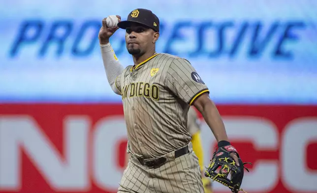 San Diego Padres' Xander Bogaerts throws out Cleveland Guardians' Steven Kwan at first base during the sixth inning of a baseball game in Cleveland, Saturday, July 20, 2024. (AP Photo/Phil Long)