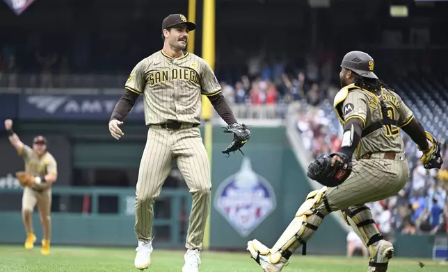 San Diego Padres starting pitcher Dylan Cease, center, celebrates his no-hitter with Padres catcher Luis Campusano after the ninth inning of a baseball game against the Washington Nationals, Thursday, July 25, 2024, in Washington. (AP Photo/John McDonnell)