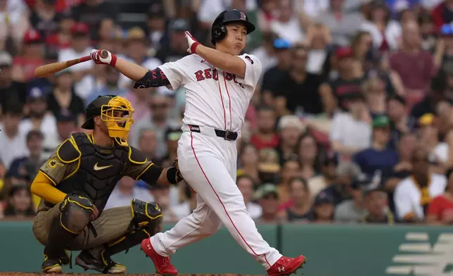 Boston Red Sox's Masataka Yoshida, right, hits a single in front of San Diego Padres catcher Kyle Higashioka, left, in the fourth inning of a baseball game, Sunday, June 30, 2024, in Boston. (AP Photo/Steven Senne)