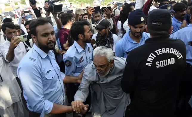 Security personnel detain Supporters of the Pakistani religious group "Jamaat-e-Islami" during a protest against the price hike and additional taxes and increasing electricity and gas tariffs, in Islamabad, Pakistan, Friday, July 26, 2024. (AP Photo/W.K. Yousafzai)