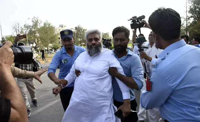 Security personnel detain Supporters of the Pakistani religious group "Jamaat-e-Islami" during a protest against the price hike and additional taxes and increasing electricity and gas tariffs, in Islamabad, Pakistan, Friday, July 26, 2024. (AP Photo/W.K. Yousafzai)