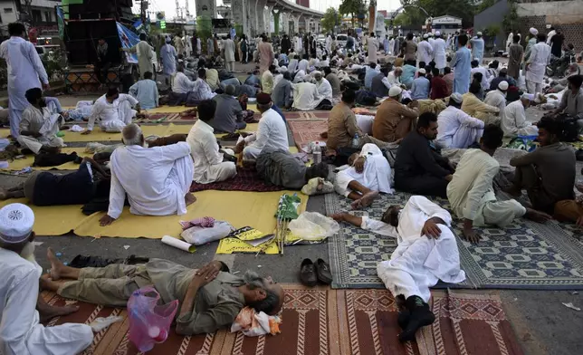 Supporters of the Pakistani religious group "Jamaat-e-Islami" sit during a protest in the city of Rawalpindi, Pakistan, Saturday, July 27, 2024. Hundreds of supporters of a key Islamist party began a sit-in protest in the garrison city of Rawalpindi late Friday after authorities detained dozens to prevent them from holding the rally in Pakistan's neighboring capital, citing security reasons, officials said. (AP Photo/W.K. Yousafzai)