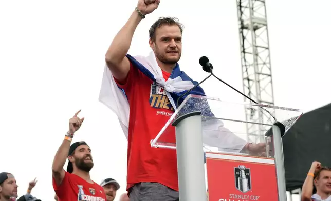 Florida Panthers' Aleksander Barkov, front, gestures while speaking during an NHL hockey rally and parade to celebrate the team's winning of the Stanley Cup, Sunday, June 30, 2024, in Fort Lauderdale, Fla. The Panthers defeated the Edmonton Oilers to win the cup. (AP Photo/Marta Lavandier)