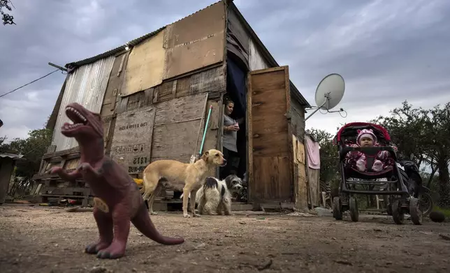 Jaqueline Alexander walks outside her house to her daughter Nicole Brandel, in Kuna Pyapy Mbarete neighborhood on the outskirts of Asuncion, Paraguay, Saturday, July 6, 2024. The heads of state from South America's Mercosur trade bloc will gather in Asuncion on July 8. (AP Photo/Rodrigo Abd)