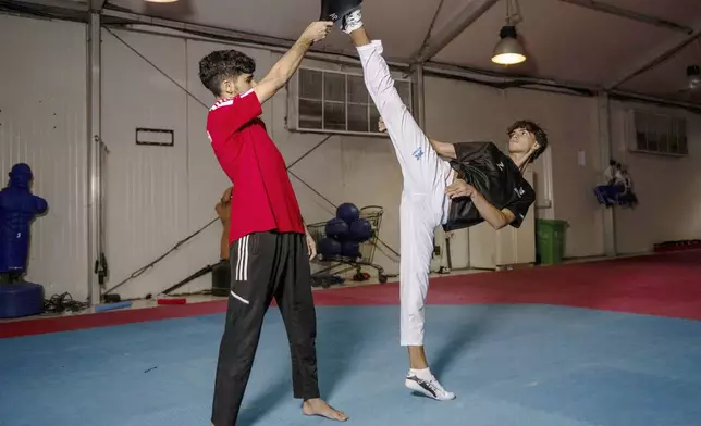 Omar Ismail, who was born in Dubai and will be competing for the Palestinian territories at the Paris Olympics, practices taekwondo in Sharjah, United Arab Emirates, on Thursday, June 20, 2024. (AP Photo/Martin Dokoupil)