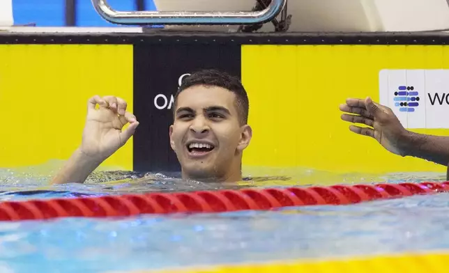 FILE – Yazan Al Bawwab, who was born in Saudi Arabia and will be competing for the Palestinian territories at the Paris Olympics, reacts during the men's 100m freestyle heats at the World Swimming Championships in Fukuoka, Japan, Wednesday, July 26, 2023. (AP Photo/Lee Jin-man, File)