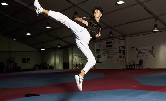 Omar Ismail, who was born in Dubai and will be competing for the Palestinian territories at the Paris Olympics, practices taekwondo in Sharjah, United Arab Emirates, on Thursday, June 20, 2024. (AP Photo/Martin Dokoupil)