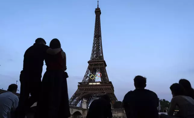 The Eiffel Tower is decorated with the Olympic rings ahead of the 2024 Summer Olympics, Wednesday, July 17, 2024, in Paris. (AP Photo/David Goldman)