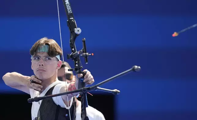 France's Baptiste Addis shoots during the men's team semifinals Archery competition against Turkey at the 2024 Summer Olympics, Monday, July 29, 2024, in Paris, France. (AP Photo/Rebecca Blackwell)