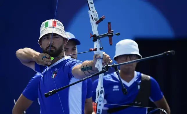 Italy's Mauro Nespoli shoots during the men's team quarterfinals Archery competition against France at the 2024 Summer Olympics, Monday, July 29, 2024, in Paris, France. (AP Photo/Rebecca Blackwell)