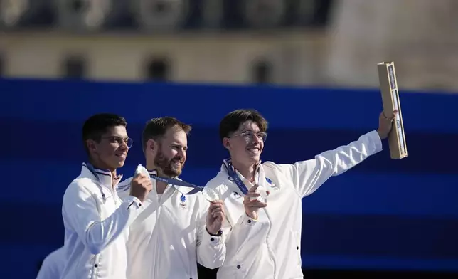 Silver medal winners, France's Baptiste Addis, left, Thomas Chirault, center and Jean-Charles Valladont, right, celebrate during the men's team medal ceremony at the 2024 Summer Olympics, Monday, July 29, 2024, in Paris, France. (AP Photo/Rebecca Blackwell)