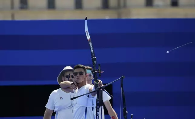 France's Thomas Chirault shoots during the men's team quarterfinals Archery competition against Italy at the 2024 Summer Olympics, Monday, July 29, 2024, in Paris, France. (AP Photo/Rebecca Blackwell)