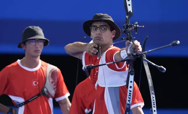 Turkey's Abdullah Yildirmis shoots during the men's team bronze medal match competition against China at the 2024 Summer Olympics, Monday, July 29, 2024, in Paris, France. (AP Photo/Rebecca Blackwell)