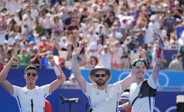 France's Thomas Chirault, left, Jean-Charles Valladont, center and Baptiste Addis, right, celebrate their win after a shoot out of the men's team semifinals Archery competition against Turkey at the 2024 Summer Olympics, Monday, July 29, 2024, in Paris, France. (AP Photo/Rebecca Blackwell)