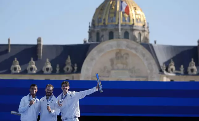 Silver medal winners, France's Baptiste Addis, left, Thomas Chirault, center and Jean-Charles Valladont, right, celebrate during the men's team medal ceremony at the 2024 Summer Olympics, Monday, July 29, 2024, in Paris, France. (AP Photo/Rebecca Blackwell)