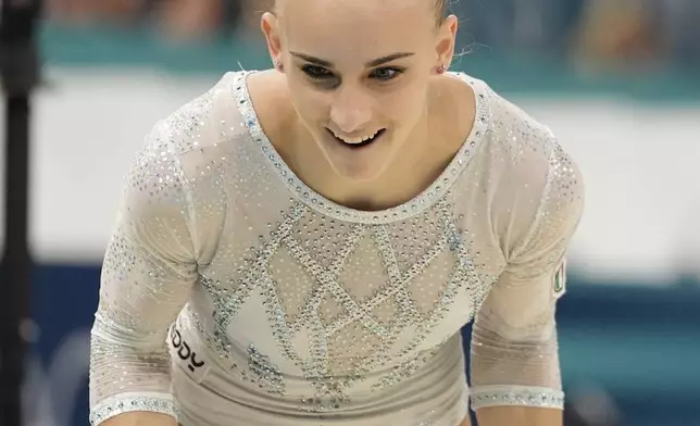 Alice D'Amato, of Italy, celebrates after performing on the balance beam during the women's artistic gymnastics team finals round at Bercy Arena at the 2024 Summer Olympics, Tuesday, July 30, 2024, in Paris, France. (AP Photo/Abbie Parr)