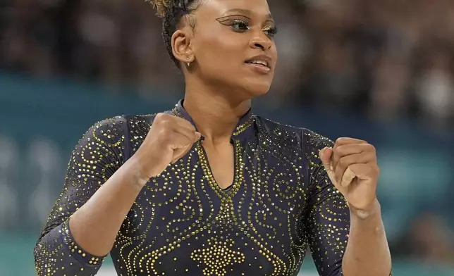 Rebeca Andrade, of Brazil, celebrates after performing on the balance beam during the women's artistic gymnastics team finals round at Bercy Arena at the 2024 Summer Olympics, Tuesday, July 30, 2024, in Paris, France. (AP Photo/Abbie Parr)