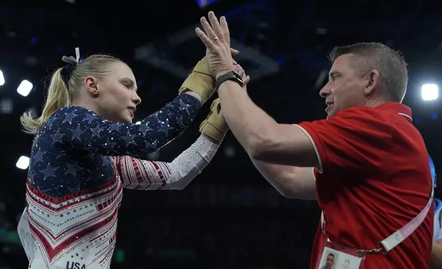 Jade Carey, of the United States, celebrates after performing on the vault during the women's artistic gymnastics team finals round at Bercy Arena at the 2024 Summer Olympics, Tuesday, July 30, 2024, in Paris, France. (AP Photo/Charlie Riedel)