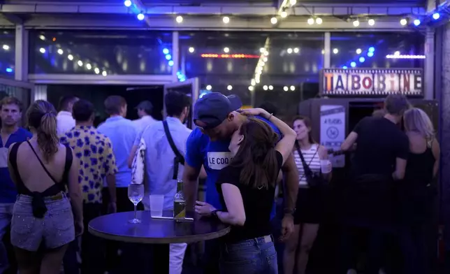 People attend the DiscOlympics at Wanderlust night club during the 2024 Summer Olympics, Monday, July 29, 2024, in Paris, France. The legendary French disco artist Cerrone played at the DiscOlympics which paid homage to the root of dance music.(AP Photo/Natacha Pisarenko)